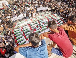 Gaza holds funeral for 100 Palestinians recovered from rubble of destroyed homes