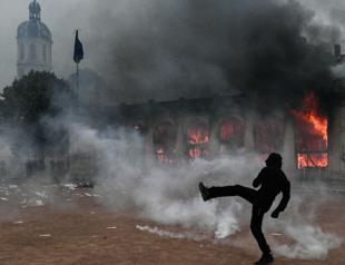 France counts cost of violent protests, 1,800 arrested