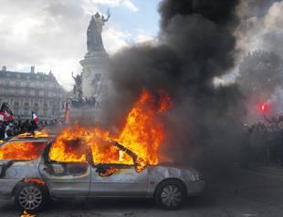 Protests banned in parts of Paris as Macron swipes at Trump