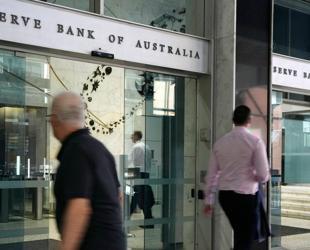 Australian central bank cuts key rate, warns of uncertainty
