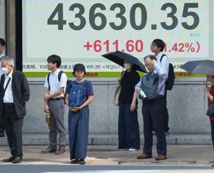 Asian stocks extend gains but US concerns hit dollar, boost gold