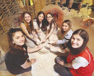 Students put away their phones to experience life 8,200 years ago