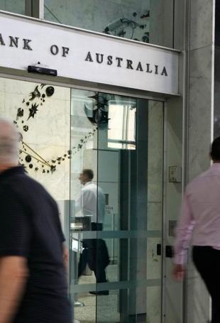 Australian central bank cuts key rate, warns of uncertainty