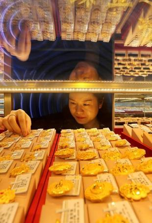 Dollar sinks on yen intervention talk, gold breaks $5,000