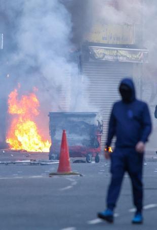 Protesters torch buildings and vehicles, block roads over Belfast stabbing