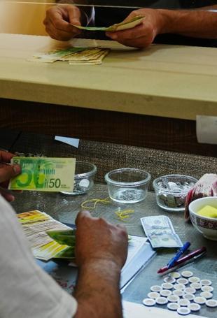 In Isareli-occupied West Bank, too much cash breaks economy
