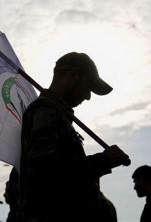 Iraq says arms of mobilization forces will not be collected
