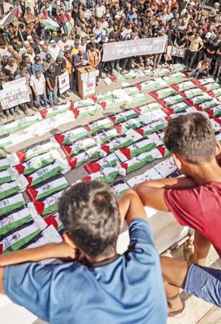 Gaza holds funeral for 100 Palestinians recovered from rubble of destroyed homes