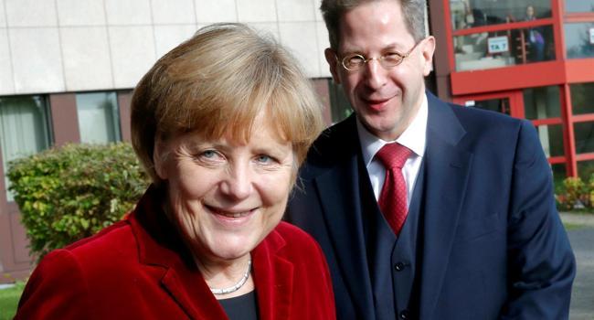Merkel removes spy chief to defuse row over far-right