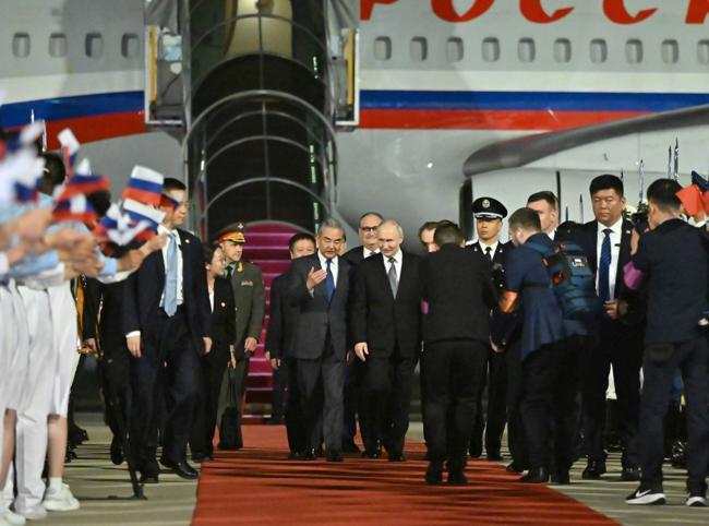 Putin lands in Beijing for talks with Xi