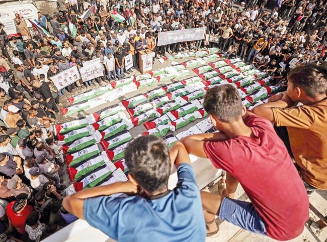 Gaza holds funeral for 100 Palestinians recovered from rubble of destroyed homes