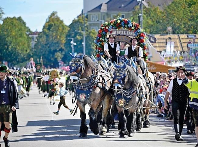 Munich’s Oktoberfest roars to life as the mayor taps first keg