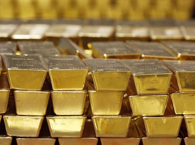 Gold slips as dollar and bond yields weigh