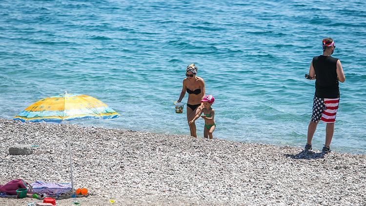 Antalyada turistlerin boş sahilde denize keyfi