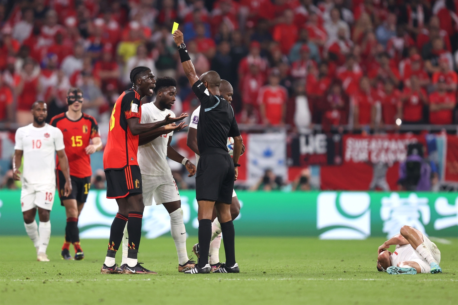 DOHA, QATAR - NOVEMBER 23: Referee Janny Sikazwe shows a yellow card to Amadou Onana of Belgium after his challenge on Stephen Eustaquio of Canada during the FIFA World Cup Qatar 2022 Group F match between Belgium and Canada at Ahmad Bin Ali Stadium on November 23, 2022 in Doha, Qatar. (Photo by Julian Finney/Getty Images)