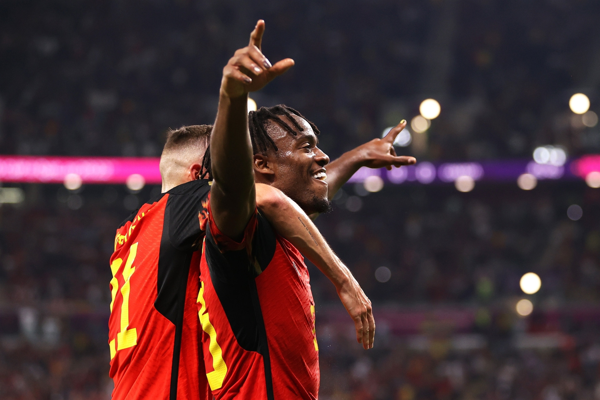 DOHA, QATAR - NOVEMBER 23: Michy Batshuayi of Belgium celebrates scoring their first goal with their teammate Timothy Castagne during the FIFA World Cup Qatar 2022 Group F match between Belgium and Canada at Ahmad Bin Ali Stadium on November 23, 2022 in Doha, Qatar. (Photo by Clive Brunskill/Getty Images)