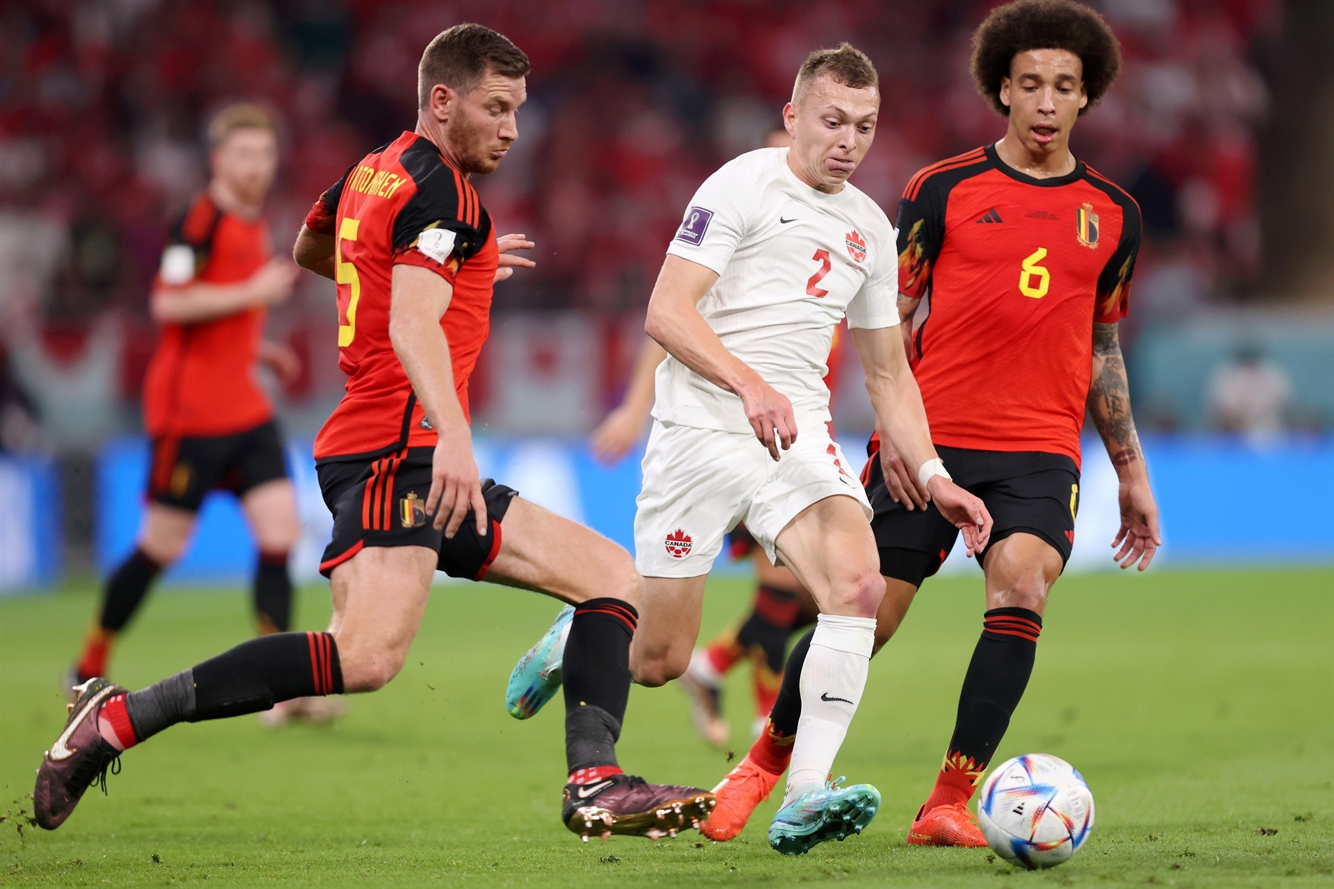 DOHA, QATAR - NOVEMBER 23: Alistair Johnston of Canada competes for the ball against Jan Vertonghen and Axel Witsel of Belgium during the FIFA World Cup Qatar 2022 Group F match between Belgium and Canada at Ahmad Bin Ali Stadium on November 23, 2022 in Doha, Qatar. (Photo by Julian Finney/Getty Images)