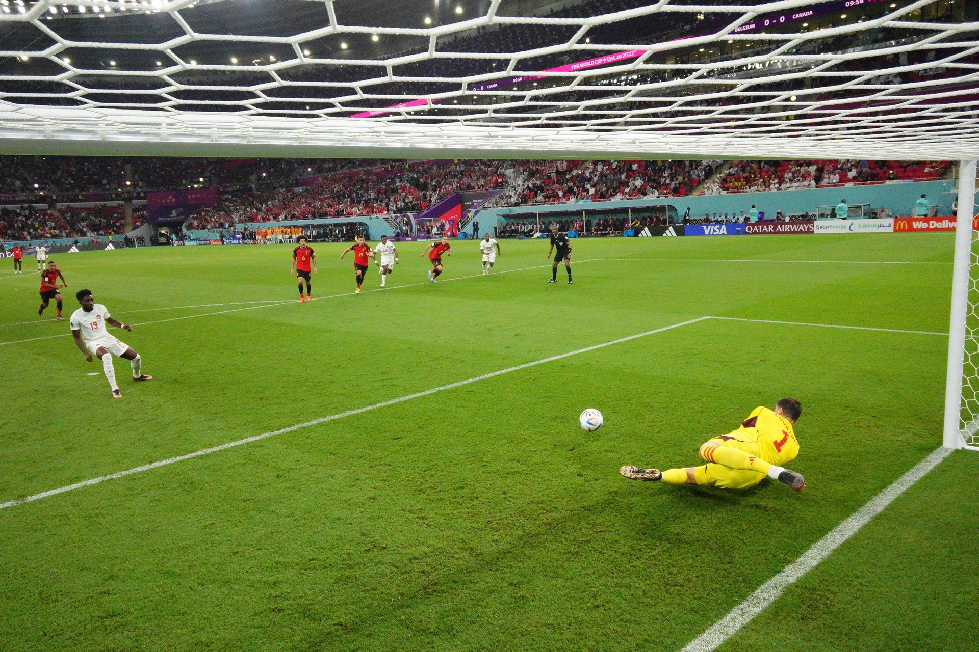 DOHA, QATAR - NOVEMBER 23: (EDITORS NOTE: In this photo taken from a remote camera from inside the goal) Thibaut Courtois of Belgium saves the penalty taken by Alphonso Davies of Canada during the FIFA World Cup Qatar 2022 Group F match between Belgium and Canada at Ahmad Bin Ali Stadium on November 23, 2022 in Doha, Qatar. (Photo by Julian Finney/Getty Images)