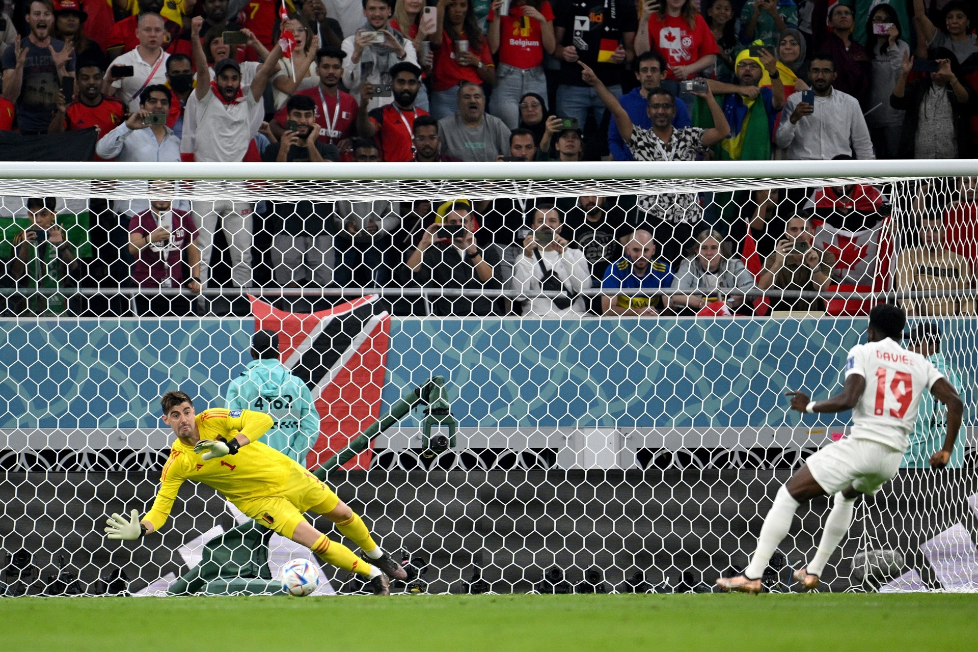 DOHA, QATAR - NOVEMBER 23: Thibaut Courtois of Belgium saves the penalty taken by Alphonso Davies of Canada during the FIFA World Cup Qatar 2022 Group F match between Belgium and Canada at Ahmad Bin Ali Stadium on November 23, 2022 in Doha, Qatar. (Photo by Matthias Hangst/Getty Images)
