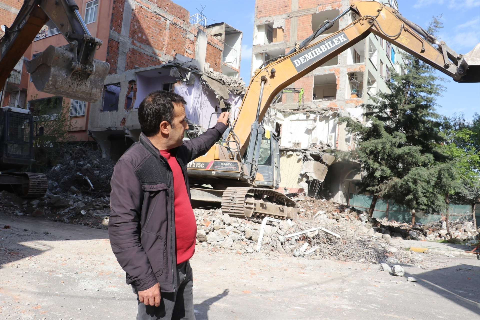 Depremde ağır hasar alan bina yıkıldı, bitişikteki apartmanın bazı odaları duvarsız kaldı Mecburen bu hasarlı evin içinde kalıyoruz