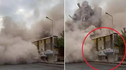 Ağır hasarlı bina yıkım sırasında yanındaki evin üzerine devrildi