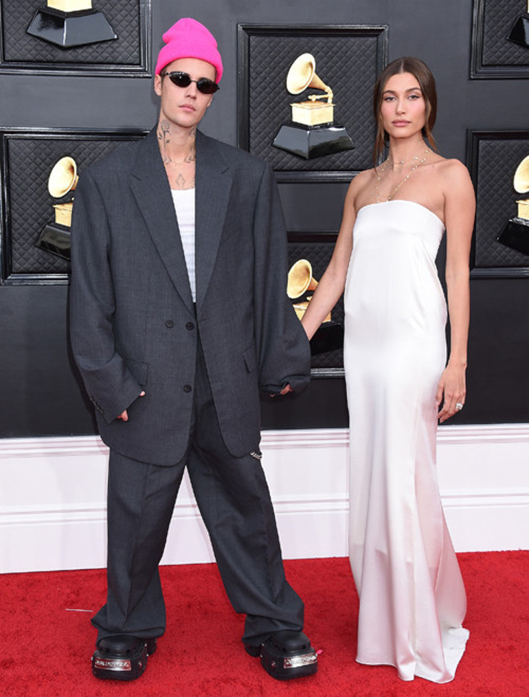 Biri market poşetiyle diğeri buruşuk elbiseyle kırmızı halıda