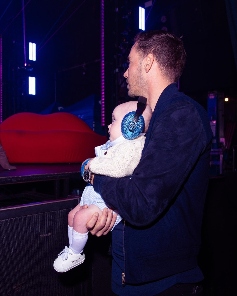 Sosyetik güzel sahnelere döndü, eşi onu kucağında minik oğullarıyla izledi