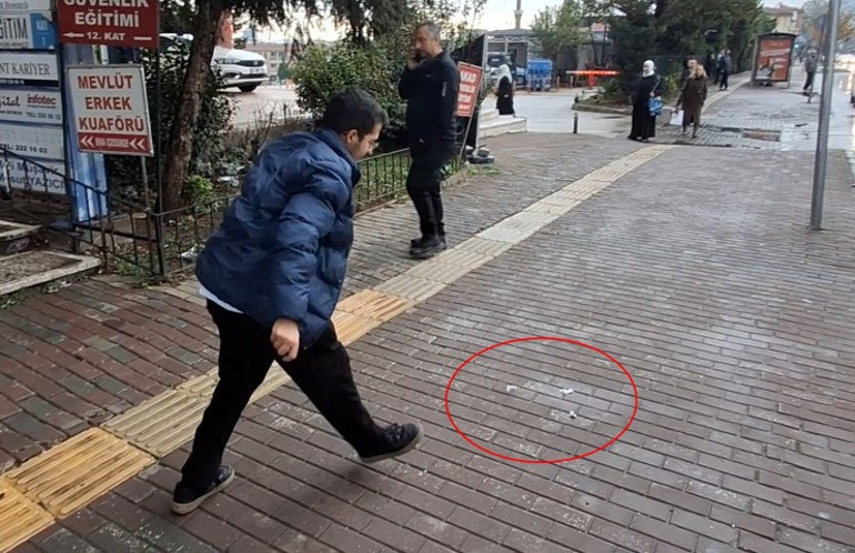 Yere atılan kağıtları toplayan kişi