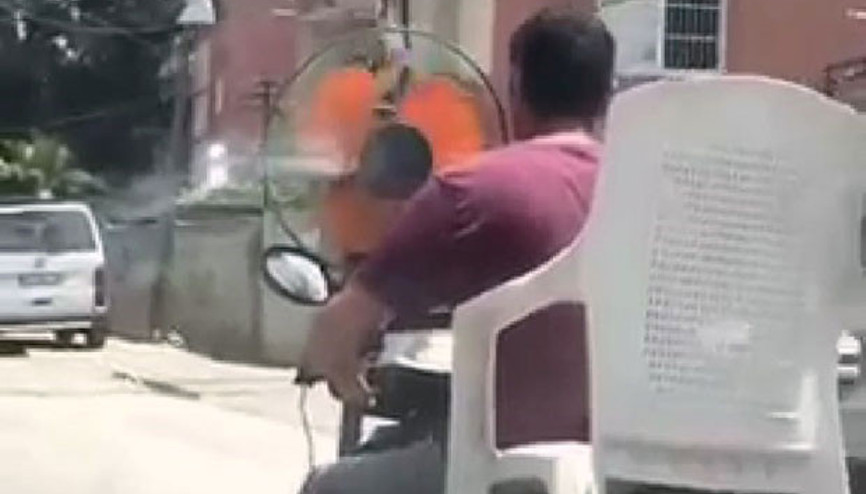 Şok görüntü Sıcaktan bunalan sürücü, motosikletin önüne pervane taktı