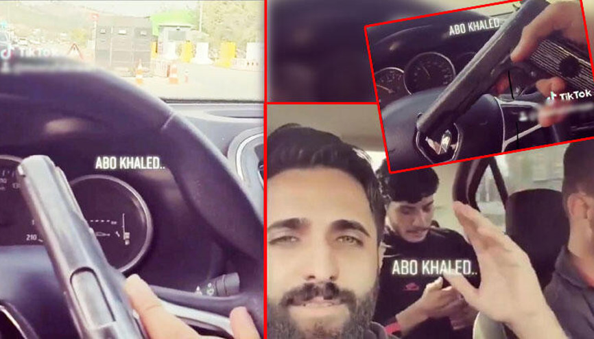 Hatayda kontrol noktasından otomobiliyle geçerken elinde tabancayla görüntü çekti