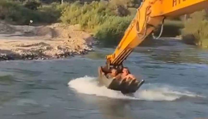 Sıcaktan bunalan işçiler kepçede böyle serinledi