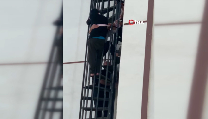 Yangın merdivenine sıkıştı, düşmemesi için çarşafla demire bağlandı